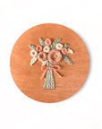 A sample of arose bouquet embroidery kit created with blush colored threads.