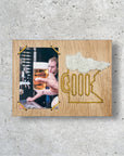 Sample of a picture frame for a Minnesota beer embroidery kit design on a cement background.