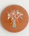 A sample of arose bouquet embroidery kit created with blush colored threads.