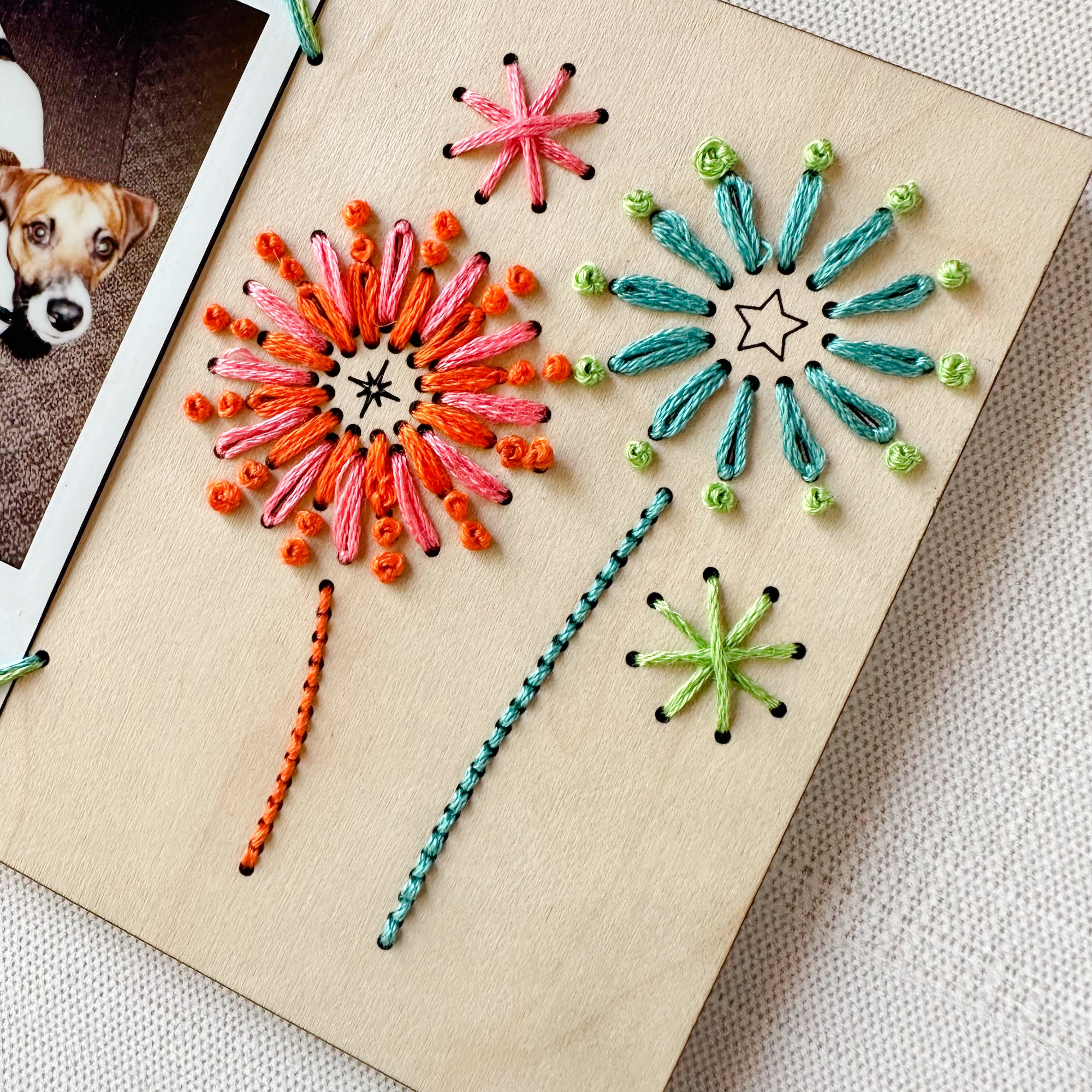 Embroidered instant photo frame with firework decoration.