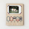 An instant photo of a dog is framed by embroidered popsicles.