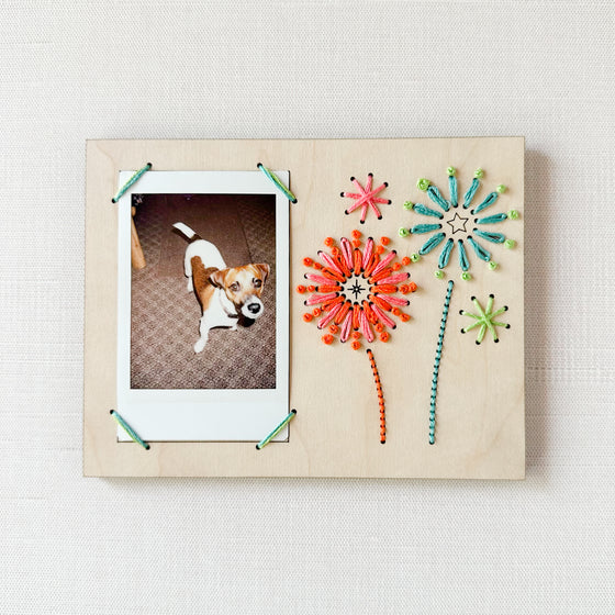Embroidered instant photo frame with firework decoration.